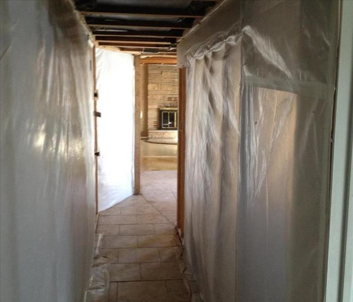 Residential hallway with 6mm plastic containment barriers on each side of the hallway 