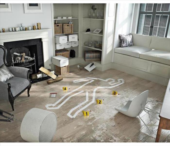 Living room with furniture and contents with white tape placed as an out line of a body after a crime scene