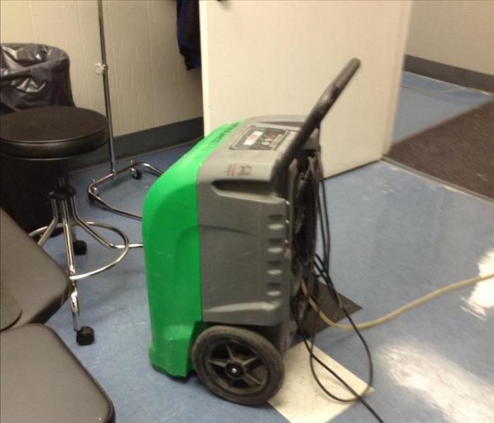 Large dehumidifier in the middle of a x-ray room, drying process after a water loss at the physical therapy building