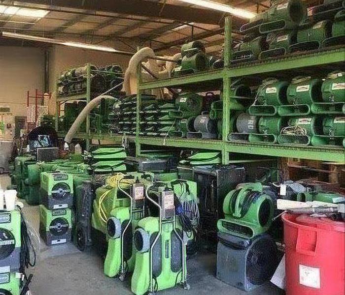 SERVPRO drying equipment inventory on shelves in a warehouse. 